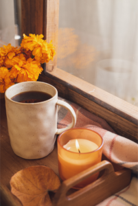 Cup of coffee and candle with fall colors